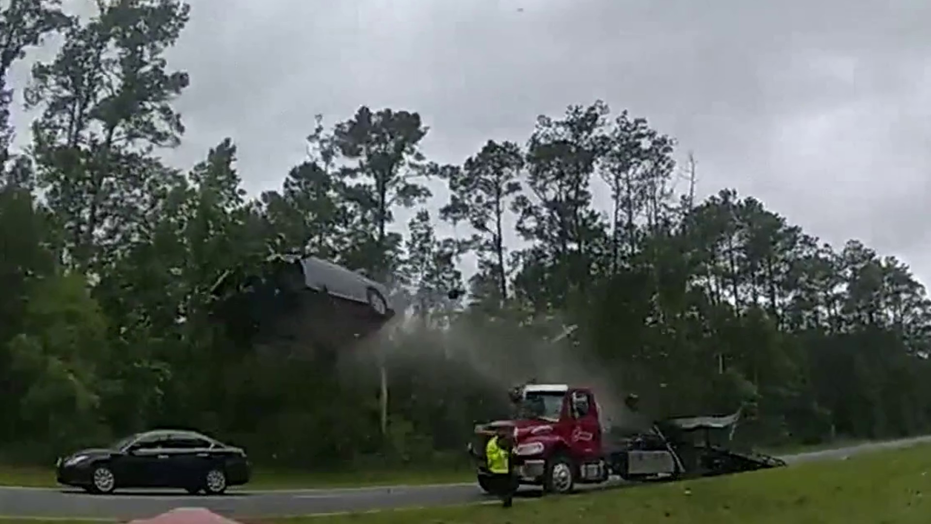 Video shows car hit tow truck ramp, fly 120-feet in the air before crashing  down on highway