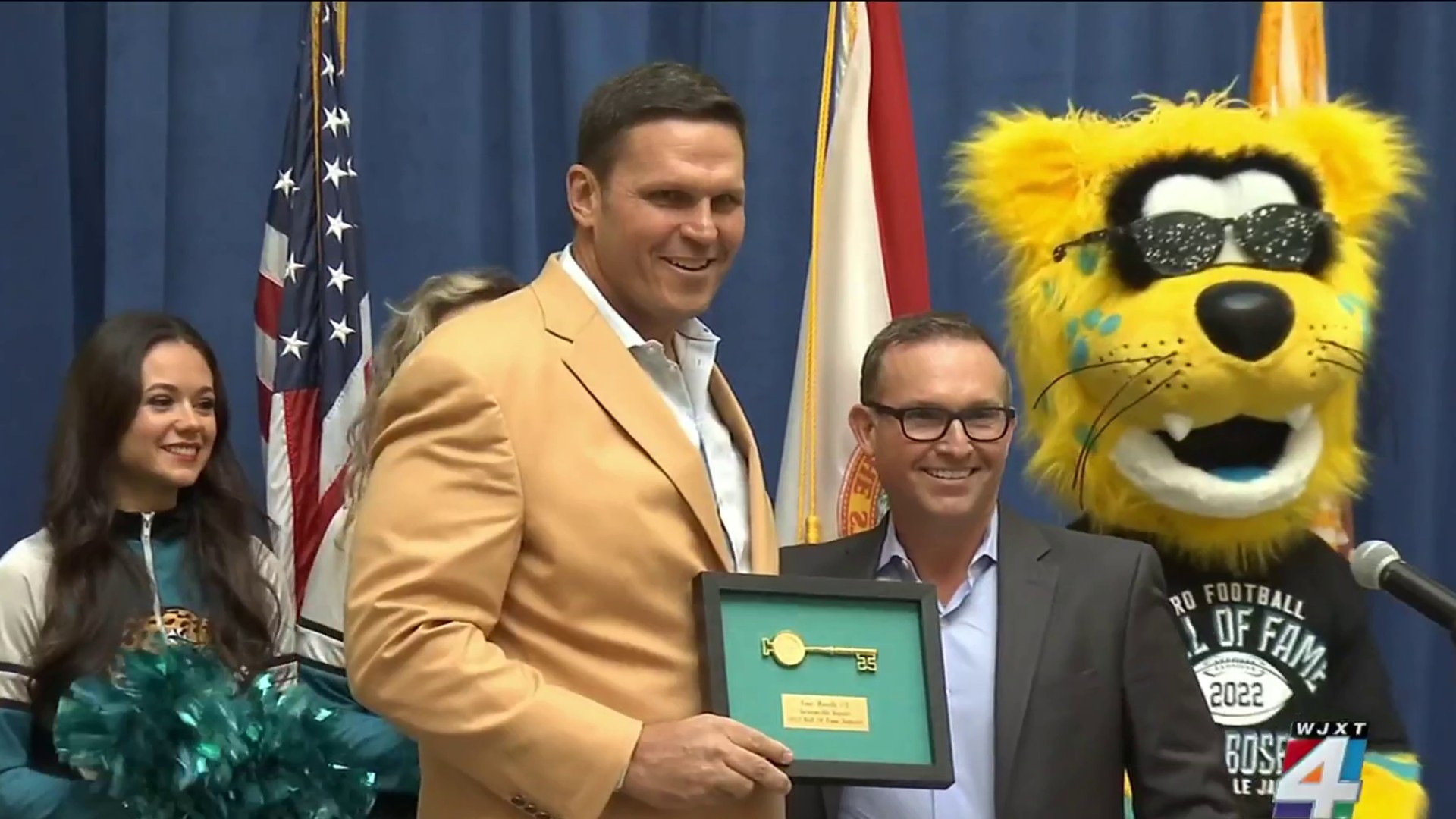 Former Jacksonville Jaguars offensive tackle Tony Boselli, center, is  presented with his Pro Football Hall of Fame ring and had his jersey number  retired, by owner Shahid Khan, left, as Pro Football